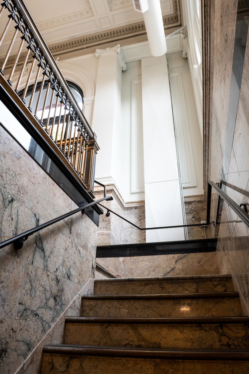 Marble stair seen from the landing, with original iron railing
