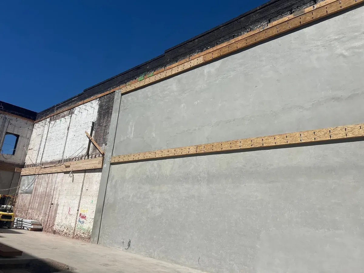 New shotcrete shear wall applied to the inside of the brick wall, Bluxome St
