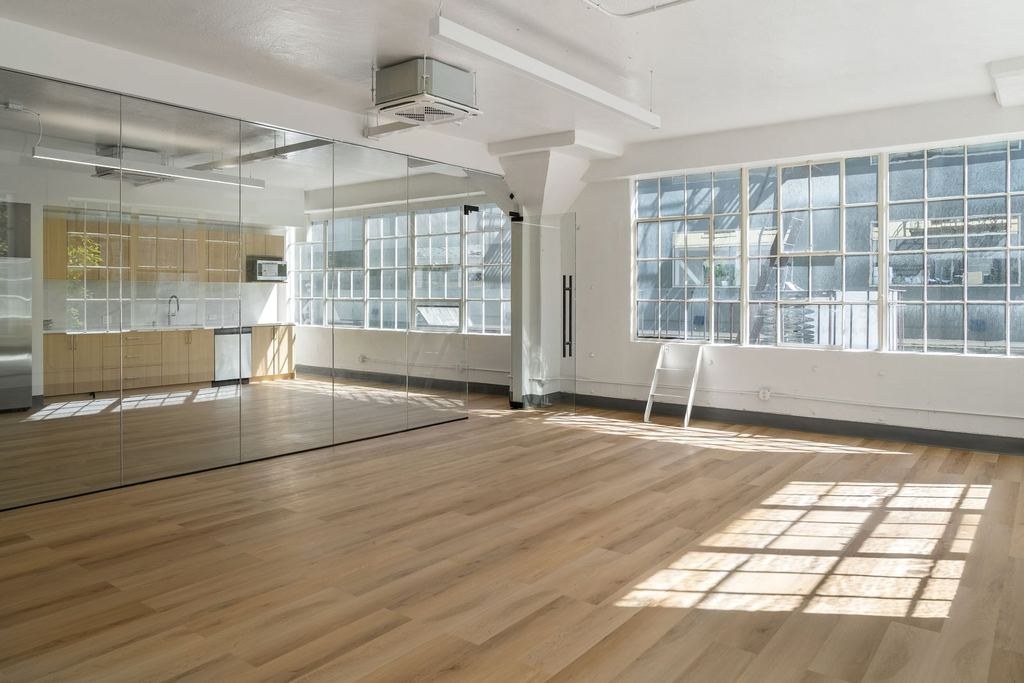 Glass-walled private office with timber floors