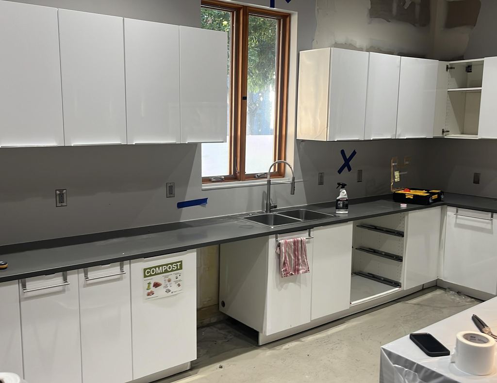After: break-room kitchen rebuilt with new cabinets, counter and sink
